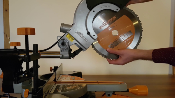 Evolution Rage 3 Chop Saw #RAGE3 SAW Side profile of DIYer touching the protective cover of the saw in a living room environment