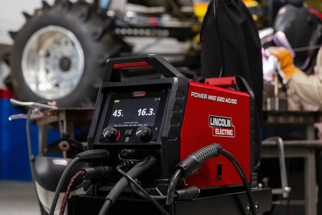 mechanic using the Lincoln Electric Power MIG 220 AC/DC Multi-Process Welder #K5379-1